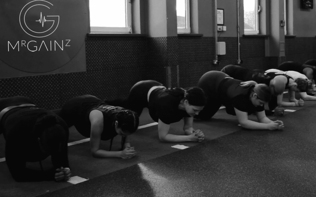 A group of people doing yoga in a gym.